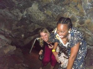 Chris and Zali squeezing through the cave